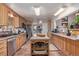 Spacious kitchen featuring an island, ample cabinets, granite countertops, stainless steel appliances, and tile flooring at 9400 W Burgundy Ave, Littleton, CO 80123