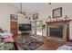 Open-concept living room features a cozy brick fireplace at 9400 W Burgundy Ave, Littleton, CO 80123