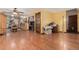 Spacious living room boasts hardwood floors, a ceiling fan, and natural light, connecting to the open kitchen at 9400 W Burgundy Ave, Littleton, CO 80123