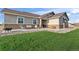 Attractive home exterior with manicured lawn, rock landscaping, and inviting front porch seating area at 16482 Ledyard S Rd, Platteville, CO 80651