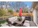 Inviting back deck features comfortable seating, an umbrella, and a view of the backyard at 5408 E Briarwood Cir, Centennial, CO 80122