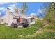 Expansive backyard with a deck, seating area, solar panels, and lush landscaping at 5408 E Briarwood Cir, Centennial, CO 80122