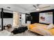 Stylish bedroom with a black accent wall, ceiling fan, modern art, and unique decor at 5408 E Briarwood Cir, Centennial, CO 80122