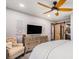 Bright bedroom with a ceiling fan, dresser, and a glimpse into an attached bathroom at 5408 E Briarwood Cir, Centennial, CO 80122