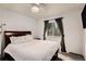 Comfortable bedroom with a large window providing natural light and ceiling fan at 5408 E Briarwood Cir, Centennial, CO 80122
