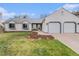 Charming home with a two-car garage, well-kept lawn, and a cozy seating area near the front door at 5408 E Briarwood Cir, Centennial, CO 80122