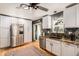 Modern kitchen with stainless steel appliances, white cabinetry and gorgeous countertops at 5408 E Briarwood Cir, Centennial, CO 80122
