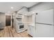 Efficient kitchen features white appliances, ample counter space, and modern lighting at 5408 E Briarwood Cir, Centennial, CO 80122