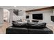 Comfortable living room with a large sectional couch, wood beam, and entertainment center at 5408 E Briarwood Cir, Centennial, CO 80122