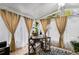 Cozy sunroom featuring a desk, large windows with sheer curtains, and a patterned rug at 5408 E Briarwood Cir, Centennial, CO 80122