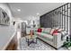 Inviting living room with hardwood floors, stylish rug, and staircase with modern divider at 71 S Quitman St, Denver, CO 80219