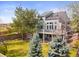 Spacious backyard with a deck, lush lawn, mature trees, and privacy fence perfect for outdoor living at 2545 Andrew Dr, Superior, CO 80027