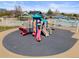 Community playground with colorful slides and play structures surrounded by a secure fence at 2545 Andrew Dr, Superior, CO 80027