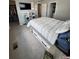 Bright bedroom with a platform bed with drawers, TV and access to a closet at 1353 Reynolds St # 5A, Fort Lupton, CO 80621