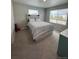 Bright bedroom with a large window, comfortable bed, and neutral tones offer a peaceful retreat at 1353 Reynolds St # 5A, Fort Lupton, CO 80621