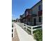 Charming townhome exteriors with well-manicured lawns and white picket fences offering a welcoming neighborhood feel at 1353 Reynolds St # 5A, Fort Lupton, CO 80621