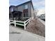 Beautiful exterior of the home with a front yard that features a fence, outdoor seating and decorative rocks at 1353 Reynolds St # 5A, Fort Lupton, CO 80621