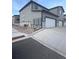 Townhome with attached rear garages, gray stone accents, and professionally maintained landscaping at 1353 Reynolds St # 5A, Fort Lupton, CO 80621