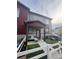 Charming townhome with inviting covered porch, decorative stone accents, and stylish exterior paint at 1353 Reynolds St # 5A, Fort Lupton, CO 80621
