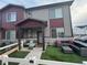 Charming townhome with inviting covered porch, decorative stone accents, and stylish exterior paint at 1353 Reynolds St # 5A, Fort Lupton, CO 80621