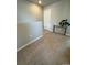 Spacious hallway features neutral paint, carpet and leads to a white door and a wall console at 1353 Reynolds St # 5A, Fort Lupton, CO 80621