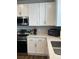 Modern kitchen featuring stainless steel appliances, white cabinetry, solid surface counters and decorative backsplash at 1353 Reynolds St # 5A, Fort Lupton, CO 80621