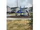Community playground with modern equipment and seating at 1353 Reynolds St # 5A, Fort Lupton, CO 80621