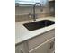 Close up of a stainless steel sink with solid surface countertops and decorative backsplash at 1353 Reynolds St # 5A, Fort Lupton, CO 80621