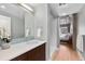 Modern bathroom with blue tiled backsplash, wood vanity, and walk-in shower at 1449 Wynkoop St # 601, Denver, CO 80202