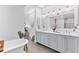 Bright and modern bathroom with dual vanity and tub at 1449 Wynkoop St # 601, Denver, CO 80202