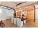 Open-concept dining area with exposed brick wall, industrial style ceiling and a contemporary light fixture at 1449 Wynkoop St # 601, Denver, CO 80202