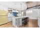 Bright kitchen featuring an island with seating, stainless appliances, and unique yellow refrigerator at 1449 Wynkoop St # 601, Denver, CO 80202