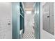 Compact laundry room with stacked washer and dryer, storage cabinets, and patterned flooring at 1449 Wynkoop St # 601, Denver, CO 80202