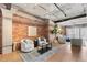 Modern living area with exposed brick wall, wood floors and contemporary furnishings at 1449 Wynkoop St # 601, Denver, CO 80202