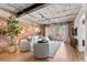 Bright living room features exposed brick, modern furniture, and sliding doors to a balcony at 1449 Wynkoop St # 601, Denver, CO 80202