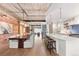 Open concept living space featuring exposed brick, modern lighting, and a stylish kitchen with bar seating at 1449 Wynkoop St # 601, Denver, CO 80202