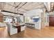 Open concept living space featuring exposed brick, modern lighting, and a stylish kitchen with bar seating at 1449 Wynkoop St # 601, Denver, CO 80202
