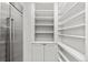 Walk-in pantry with shelving, cabinetry, and stainless steel refrigerator at 1449 Wynkoop St # 601, Denver, CO 80202