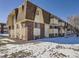 Brick apartment building with multiple units and balconies, snow on the ground at 10211 Ura Ln # 7-107, Thornton, CO 80260