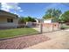 Fenced backyard featuring a well-maintained lawn, brick patio, and mature trees at 2685 W Asbury Ave, Denver, CO 80219