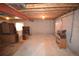 Unfinished basement area with concrete walls, open ceiling, and utility connections at 2685 W Asbury Ave, Denver, CO 80219