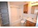 A bathroom features a shower and bathtub combination, a toilet, and vanity at 2685 W Asbury Ave, Denver, CO 80219