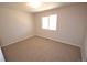 A bedroom features a neutral carpet, white walls, and a window providing natural light at 2685 W Asbury Ave, Denver, CO 80219