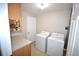 Bright laundry area with washer, dryer, storage and a countertop folding area at 2685 W Asbury Ave, Denver, CO 80219