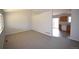 Open-concept living room with new carpet and views into kitchen area at 2685 W Asbury Ave, Denver, CO 80219