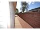 Narrow side yard between home and brick fence at 2685 W Asbury Ave, Denver, CO 80219