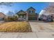 Charming two-story home featuring a well-manicured lawn and an attached two-car garage at 11405 Iola St, Commerce City, CO 80640