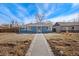 Charming blue single-story home featuring a paved walkway, manicured lawn, and inviting curb appeal at 2930 Oneida St, Denver, CO 80207