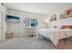 Minimalist bedroom with a computer desk, TV, neutral color palette and natural light to create a calm and productive space at 6850 Xavier Cir # 5, Westminster, CO 80030