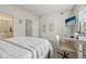 Bright bedroom features a soft white bed, workspace, and ample closet storage at 6850 Xavier Cir # 5, Westminster, CO 80030